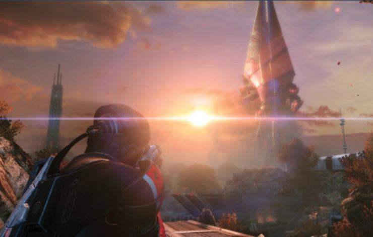 Protagonista di Mass Effect che osserva un paesaggio alieno illuminato dal tramonto